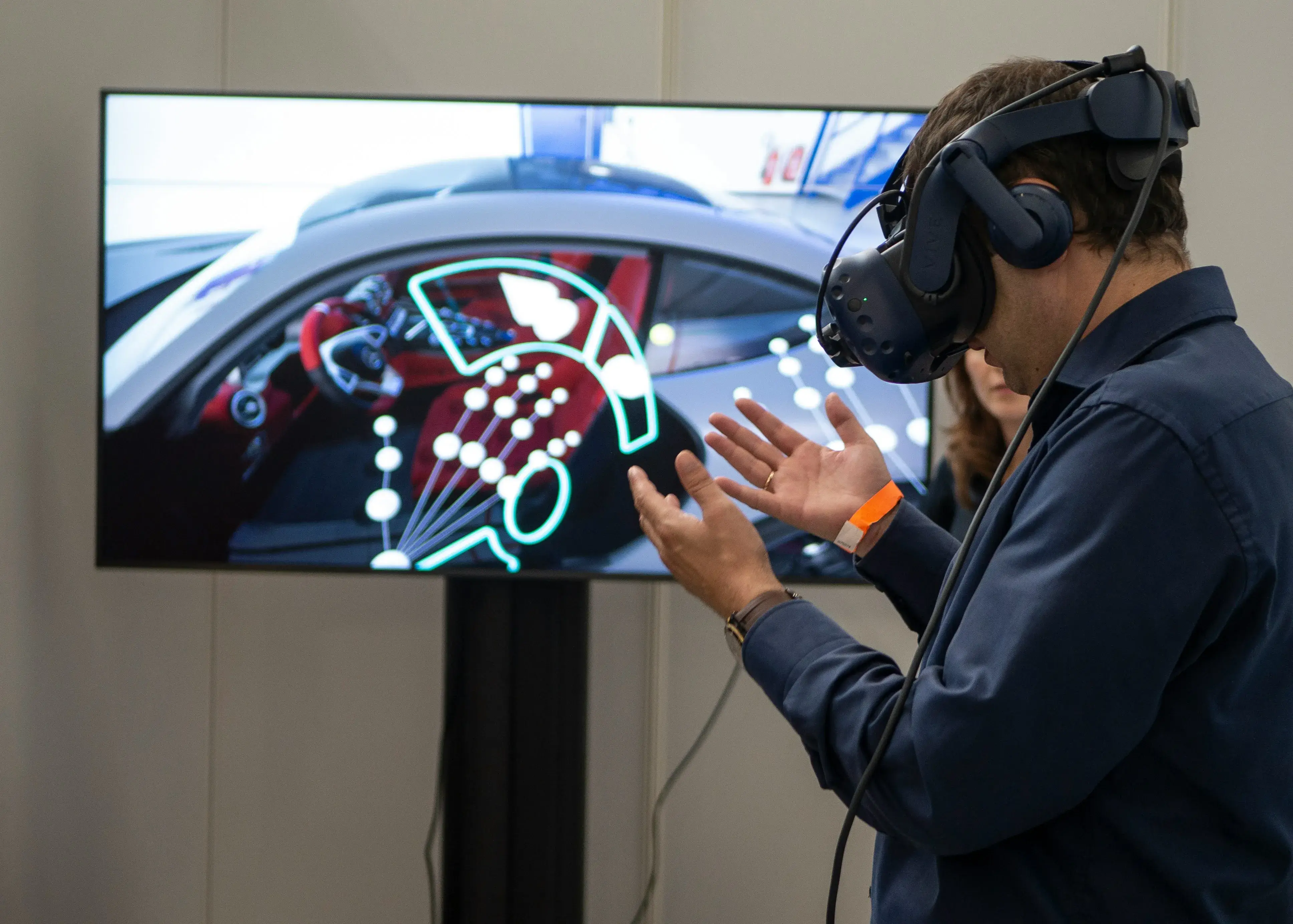 Person in a VR headset interacting with a 3D vehicle model